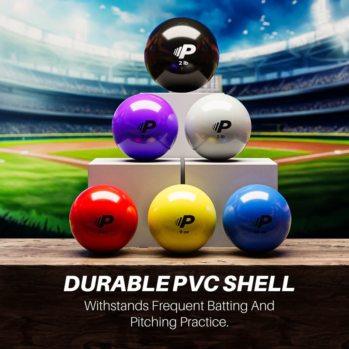 Set of colorful Pylo balls displayed on a wooden surface with a baseball stadium in the background. The balls, labeled with weights from 5 oz to 2 lb, have a durable PVC shell. Text overlay reads: 'DURABLE PVC SHELL - Withstands Frequent Batting and Pitching Practice.