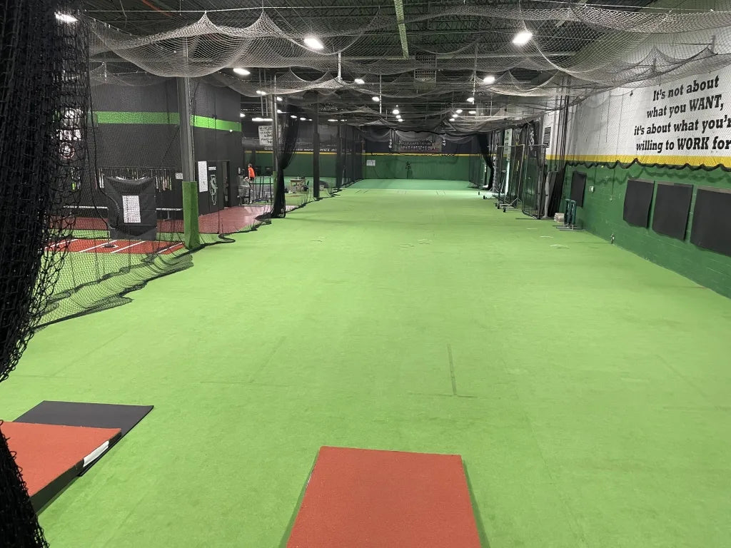 Indoor turf space designed for year-round baseball and pitching development.
