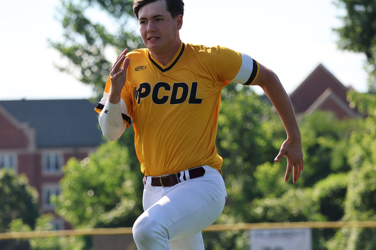 PCDL player sprinting down the base path in a yellow jersey