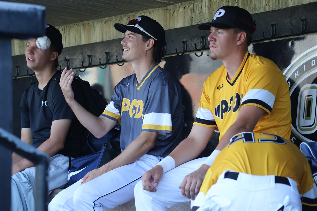 PCDL players laughing together in the dugout