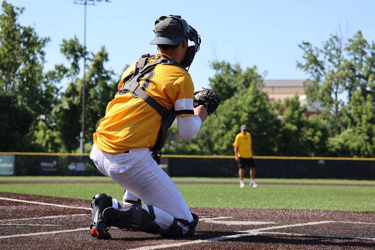 PCDL catcher receiving a pitch behind home plate