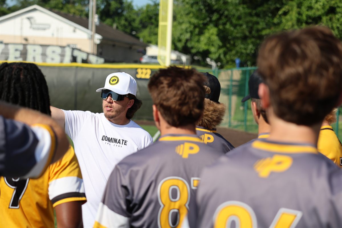 PCDL coach giving instruction to players on the field